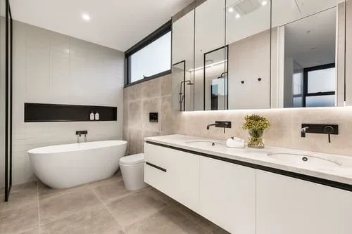 Elegant modern bathroom with tiled walls and floor and a freestanding tub
