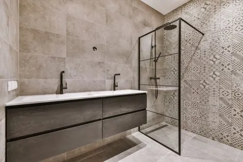 Bathroom tile installation with floor-to-ceiling wall tile, glass shower and floating vanity in a Utah County home