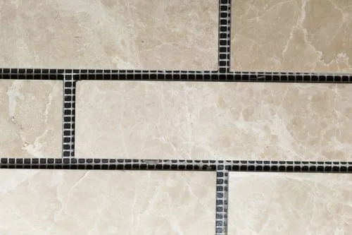 Close-up of tile being installed showing material texture and precise spacing