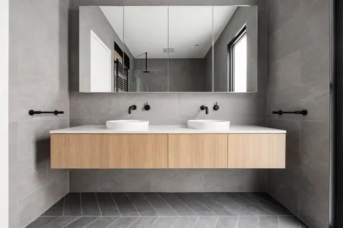 Newly tiled modern bathroom with glass shower and floating vanity by Fast Tile & Renovations