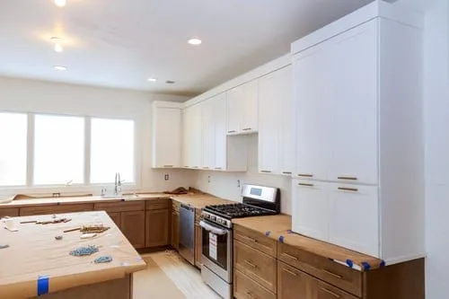 Kitchen mid-remodel with new cabinetry ready for tile and backsplash work